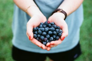 health and wellness UX writing. Photo of woman holding blueberries
