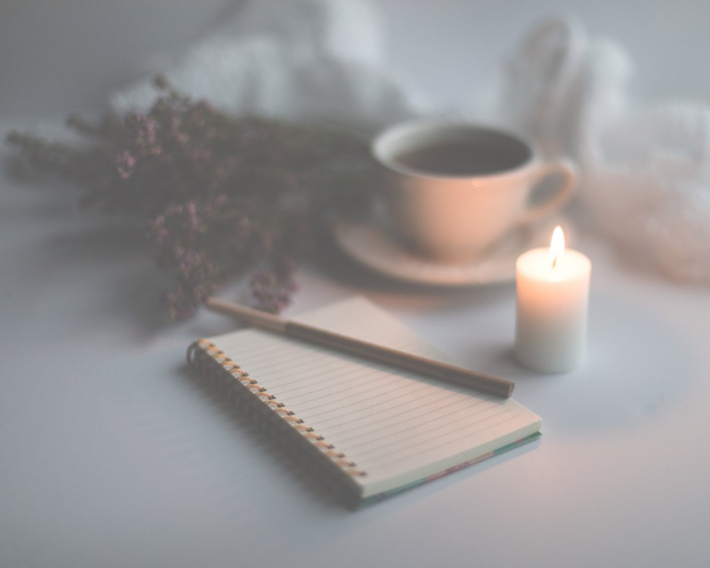 gratitude journaling, candle and a cup of coffee